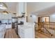 Kitchen with marble countertops, stainless appliances, hardwood floors and entry to the second floor at 2066 E 129Th Ave, Thornton, CO 80241