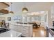 This eat-in kitchen features light hardwood floors, pendant lighting, island and dining area at 2066 E 129Th Ave, Thornton, CO 80241