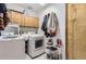 Laundry room with washer, dryer, storage cabinets and rack, and exterior access at 2066 E 129Th Ave, Thornton, CO 80241