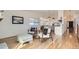 Living room showcasing hardwood floors, bright window, and open access to the kitchen and entryway at 2066 E 129Th Ave, Thornton, CO 80241