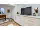 Living room wet bar features marble countertops, gold hardware, and adjacent television viewing area at 2066 E 129Th Ave, Thornton, CO 80241