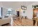 Open-concept living room boasts hardwood floors, vaulted ceiling, and modern decor at 2066 E 129Th Ave, Thornton, CO 80241