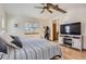 Comfortable main bedroom featuring a wooden ceiling fan and a modern entertainment center at 2066 E 129Th Ave, Thornton, CO 80241