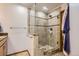Tiled shower featuring a glass enclosure and built-in bench at 2066 E 129Th Ave, Thornton, CO 80241