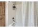 White-tiled shower and tub at 2066 E 129Th Ave, Thornton, CO 80241