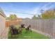 Virtually staged backyard with patio furniture and rock border at 3608 N Grape St, Denver, CO 80207