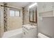 Updated bathroom features a granite vanity, tile shower, and updated fixtures at 3608 N Grape St, Denver, CO 80207