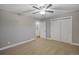 Bedroom with neutral walls, ceiling fan, and double door closet at 3608 N Grape St, Denver, CO 80207