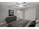 Virtually staged bedroom with double doors and ceiling fan at 3608 N Grape St, Denver, CO 80207