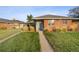 Brick ranch home with a landscaped yard and a blue front door at 3608 N Grape St, Denver, CO 80207