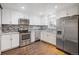 Updated kitchen with stainless steel appliances and wood floors at 3608 N Grape St, Denver, CO 80207