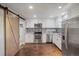 Modern kitchen with stainless steel appliances and wood flooring at 3608 N Grape St, Denver, CO 80207