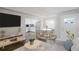 Virtually staged living room with kitchen view, hardwood floors, and modern furniture at 3608 N Grape St, Denver, CO 80207