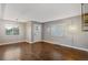 Living room with hardwood floors and updated light fixture at 3608 N Grape St, Denver, CO 80207