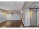 Living room with hardwood floors and barn door at 3608 N Grape St, Denver, CO 80207