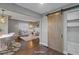 Open concept living room with barn door and view to the dining area at 3608 N Grape St, Denver, CO 80207