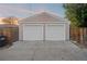 Two-car garage with white doors and light beige exterior at 3608 N Grape St, Denver, CO 80207