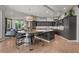 Open kitchen boasts a large island, custom cabinetry, and breakfast bar at 5831 S Albion Ct, Greenwood Village, CO 80121