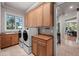 Convenient laundry room with washer, dryer, and ample cabinet storage at 5831 S Albion Ct, Greenwood Village, CO 80121