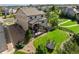 Expansive backyard featuring lush green grass, a trampoline, and a charming home with deck at 22268 E Hidden Trail Dr, Parker, CO 80138