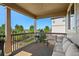 Relaxing covered deck with comfortable seating, a grill, and scenic views of the surrounding landscape at 22268 E Hidden Trail Dr, Parker, CO 80138