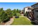 Expansive backyard featuring lush lawn, mature trees, and a fun trampoline, perfect for outdoor enjoyment at 22268 E Hidden Trail Dr, Parker, CO 80138
