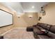 Cozy carpeted basement featuring a sectional sofa and media projector, perfect for entertainment at 22268 E Hidden Trail Dr, Parker, CO 80138
