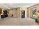 Open basement space with a large sliding glass door, and an office area featuring a built-in desk at 22268 E Hidden Trail Dr, Parker, CO 80138
