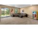 Spacious basement with a large sectional sofa, walk-out access, and vintage jukebox at 22268 E Hidden Trail Dr, Parker, CO 80138