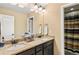 Double vanity bathroom with granite countertop and decorative mirror at 22268 E Hidden Trail Dr, Parker, CO 80138