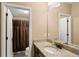 Well-lit bathroom with a granite countertop, stylish sink, and a shower with a brown curtain at 22268 E Hidden Trail Dr, Parker, CO 80138