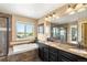 Spa-like bathroom with a soaking tub, glass shower and double sink vanity at 22268 E Hidden Trail Dr, Parker, CO 80138
