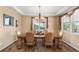 Elegant dining room with a wooden table set for six, chandelier lighting, and a patterned rug at 22268 E Hidden Trail Dr, Parker, CO 80138
