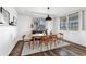 Modern dining room with hardwood floors, a long wooden table, and a stylish pendant light at 22268 E Hidden Trail Dr, Parker, CO 80138