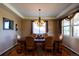 Traditional dining room with a large wooden table, upholstered chairs, and a decorative chandelier at 22268 E Hidden Trail Dr, Parker, CO 80138