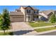 Two-story home with a combination of brick and siding, a two-car garage, and tidy landscaping at 22268 E Hidden Trail Dr, Parker, CO 80138