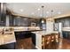 Spacious kitchen with black cabinetry, stainless steel appliances, and a granite-topped island at 22268 E Hidden Trail Dr, Parker, CO 80138
