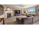 Cozy living room featuring a fireplace, large windows offering natural light, and plush seating at 22268 E Hidden Trail Dr, Parker, CO 80138