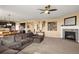 Inviting living space with a fireplace, hardwood floors, and seamless flow into the kitchen at 22268 E Hidden Trail Dr, Parker, CO 80138