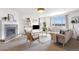 Bright living room with a fireplace, a large window with views, and neutral furnishings at 22268 E Hidden Trail Dr, Parker, CO 80138