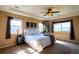 Inviting main bedroom with a king-size bed, soft lighting, and a view of the neighborhood at 22268 E Hidden Trail Dr, Parker, CO 80138