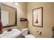 Cozy powder room with decorative mirror, modern fixtures, and stylish accents at 22268 E Hidden Trail Dr, Parker, CO 80138