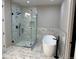 Modern bathroom with soaking tub, large marble shower, marble tile, and black fixtures at 13350 Imboden Rd, Hudson, CO 80642