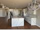 Bright, modern kitchen with white cabinets, marble countertops, stainless steel appliances, and decorative lighting at 13350 Imboden Rd, Hudson, CO 80642