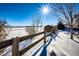 Snowy backyard with wooden fence and open space at 5808 S Duquesne Ct, Aurora, CO 80016