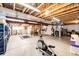 Unfinished basement with exercise equipment and storage at 5808 S Duquesne Ct, Aurora, CO 80016