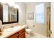 Clean bathroom with a single sink vanity, toilet, and shower at 5808 S Duquesne Ct, Aurora, CO 80016