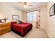 Cozy bedroom with a double bed, window with curtains, and wood dresser at 5808 S Duquesne Ct, Aurora, CO 80016