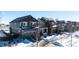 Two-story house with gray siding, snow-covered yard, and attached garage at 5808 S Duquesne Ct, Aurora, CO 80016