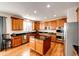 Modern kitchen with an island, granite countertops, and stainless steel appliances at 5808 S Duquesne Ct, Aurora, CO 80016